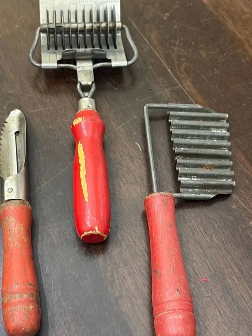 Set of chippy red wood handle utensils